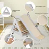 A children's wooden climbing triangle with a slide, set up on a rug indoors. Anteprima dell’immagine prodotto