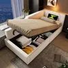 A bed with storage, set up in a room with a city view at night. Voir les images du produit