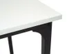 A close-up view of the corner of a white desk with a black metal frame. Produktbild-Vorschau