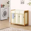 A laundry room scene with a washing machine and a multi-compartment laundry sorter. Anteprima dell’immagine prodotto
