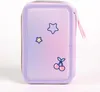 A close-up studio shot of a pencil case with a gradient of purple and pink, decorated with cartoon stars and cherries. Voir les images du produit