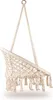 A beige macrame hanging chair with fringe, suspended from a metal ring. Podgląd zdjęcia produktu