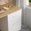 A close-up view of a desk with a wooden top and white drawers. Produktbild-Vorschau