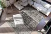 A living room scene with a sectional sofa, a rug, and a pouf. Produktbild-Vorschau
