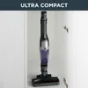 A black and purple cordless vacuum cleaner is shown standing upright inside a white cabinet. Produktbild-Vorschau