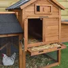 A close-up view of a wooden chicken coop with a wire mesh enclosure and a chicken inside. Anteprima dell’immagine prodotto