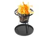 A black metal fire pit with burning wood and flames, set on a black circular ash tray with three legs. Produktbild-Vorschau
