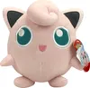A pink plush toy of the Pokemon character Jigglypuff is shown against a white background. A tag with Pokemon branding is attached to its right side. Produktbild-Vorschau