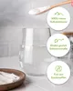 A close-up of a glass of water with powder being added from a wooden spoon, alongside informational circles. Produktbild-Vorschau