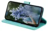 A teal flip case for a Samsung Galaxy S23 phone, showing the phone screen displaying a bouquet of blue flowers. Produktbild-Vorschau