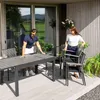 A couple is setting up a patio dining set on a wooden deck. Náhled obrázku produktu