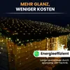 A wooden shed decorated with strings of warm white LED lights on the roof and hanging down. Produktbild-Vorschau