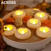 Floating LED candles in a bowl with decorative flowers. Produktbild-Vorschau