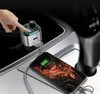 A hand is shown pressing a button on a car charger plugged into a car's power outlet, while a smartphone is connected and charging. Podgląd zdjęcia produktu