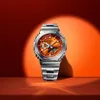 A G-Shock watch with an orange face and silver band is displayed against a gradient orange and red background with a spotlight effect. Produktbild-Vorschau