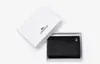 A black Lacoste wallet is presented in its white branded box, which is open. Anteprima dell’immagine prodotto