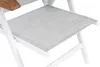 A close-up view of a white folding chair with a grey fabric seat and a wooden armrest. Produktbild-Vorschau