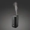 A black humidifier emitting steam against a dark gray background. Náhľad obrázku produktu