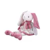 A plush toy rabbit sitting down, isolated on a white background. Produktbild-Vorschau