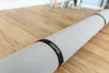 A rolled-up rug on a wooden floor. Produktbild-Vorschau