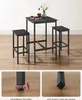 A black bar table set with two stools, shown in a room setting with a light-colored wall and wooden floor. Close-up shots of the table legs are shown at the bottom. Produktbild-Vorschau