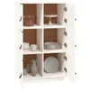 A white wooden cabinet with multiple open shelves, showcasing various kitchen items like plates, cups, and a jar of food. Voir les images du produit