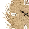 Close-up of a woven straw clock face with white numbers and black hands. Podgląd zdjęcia produktu
