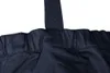 A close-up view of the top seam and strap attachment of a pair of navy blue work pants. Náhled obrázku produktu