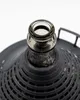 Close-up view of the neck and opening of a glass carboy covered by a protective plastic basket. Produktbild-Vorschau