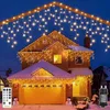 A house decorated with Christmas lights in the snow. Produktbild-Vorschau