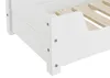 Close-up view of the corner of a white wooden dog bed with visible wooden slats for the mattress support. Produktbild-Vorschau