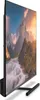 A side view of a large, modern television displaying a scenic landscape. Produktbild-Vorschau