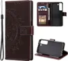 A collage of images showing a brown leather flip phone case with a mandala design, its interior card slots, and a separate view of the phone holder.