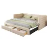 A beige upholstered daybed with green and striped bedding, showing two open storage drawers underneath. Podgląd zdjęcia produktu