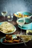A table setting with food and wine. Produktbild-Vorschau