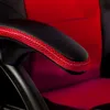 A close-up view of the armrest of a red and black office chair. Produktbild-Vorschau