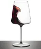 A wine glass with red wine splashing inside, isolated on a white background. Produktbild-Vorschau