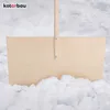 A wooden snow shovel with a handle is partially submerged in snow. Náhled obrázku produktu