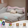 A bed with LED lighting and a remote control, showcasing its features. Produktbild-Vorschau