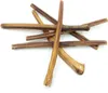 A pile of dried dog chews arranged in a star-like pattern on a white background. Podgląd zdjęcia produktu