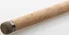 A close-up view of the handle of a fishing rod, made of cork with a metal accent. Produktbild-Vorschau