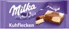 A Milka Kuhflecken chocolate bar wrapper with a depiction of a cow and mountains. Náhled obrázku produktu