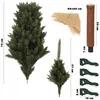 Components of a Christmas tree are laid out on a white background, including tree sections, a trunk, a base, and a burlap cloth. Anteprima dell’immagine prodotto