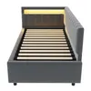 A grey upholstered bed frame with a slatted mattress base and integrated LED lighting in the headboard. Anteprima dell’immagine prodotto