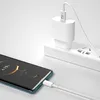 A white USB-C charging cable is plugged into a smartphone and a white power adapter plugged into a white power strip. Anteprima dell’immagine prodotto