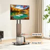 A TV stand with a TV mounted on it, placed in a room with curtains and a plant. Anteprima dell’immagine prodotto