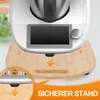 A close-up marketing image of a kitchen appliance stand with arrows indicating placement. Voir les images du produit
