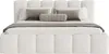 A white upholstered bed with pillows and a throw blanket. Produktbild-Vorschau