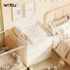 A nursery room with a crib, a changing station on a dresser, and a bed. Náhľad obrázku produktu