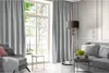 A living room scene with a sofa, armchair, and curtains. Produktbild-Vorschau